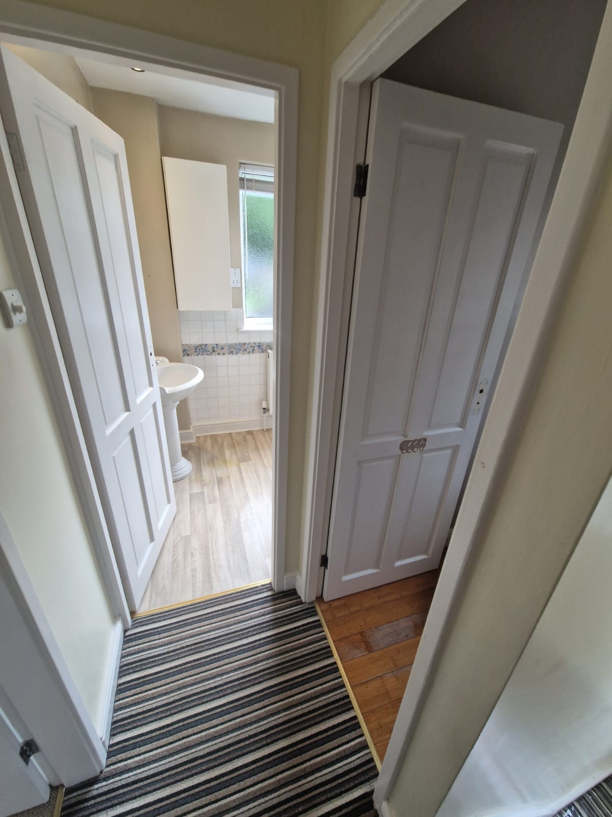 The landing before the work, showing the two separate doors into the bathroom and the WC