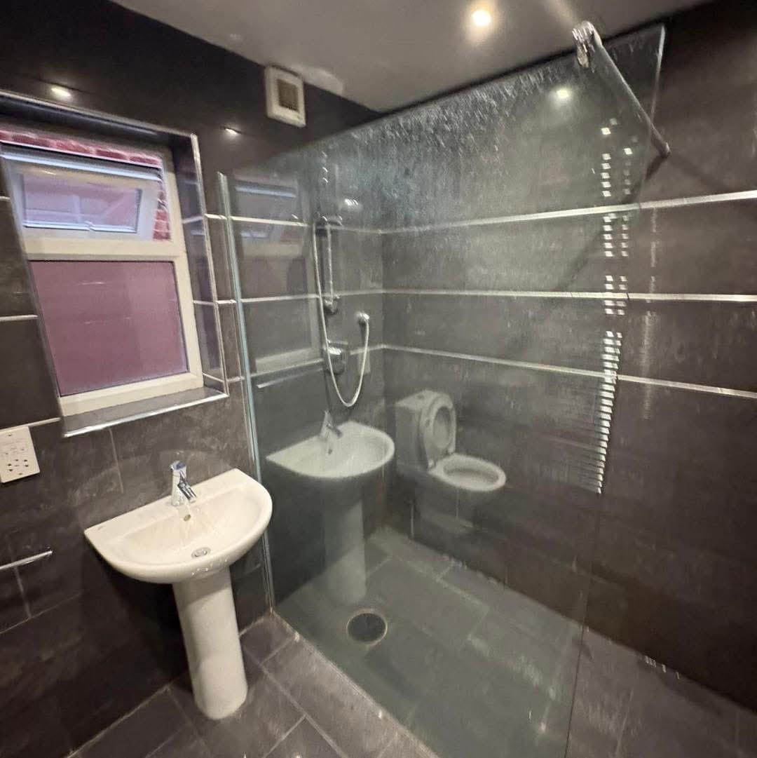 bees dark tiled bathroom walk in shower