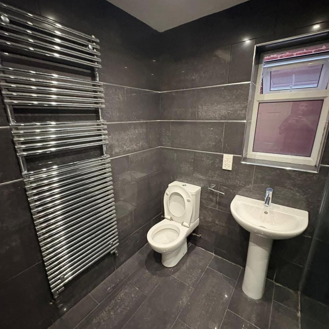 dark grey tiled bathroom chrome radiator